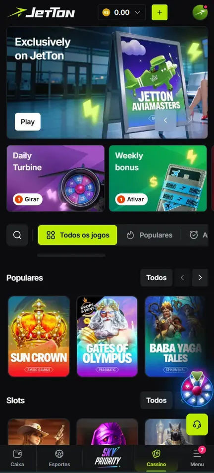 Tela inicial da Jetton no celular: saldo em R$, banner em inglês com botão Play, atalhos Daily Turbine (Girar) e Weekly bonus (Ativar), fileira Populares e barra de navegação inferior
